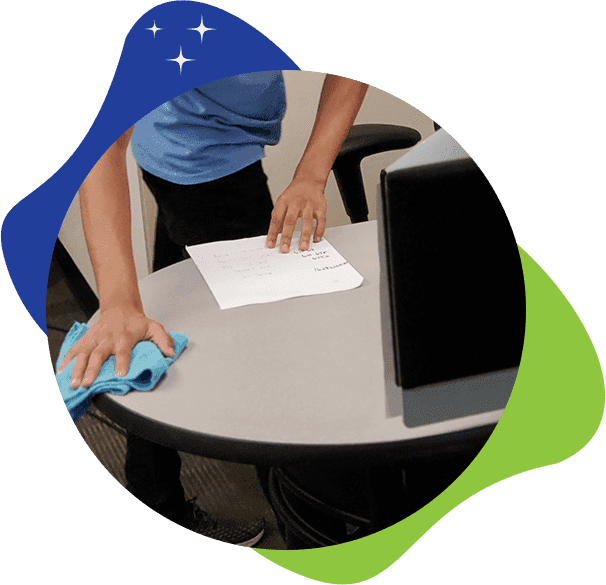 Cleaner dusting air vents and baseboards in an office